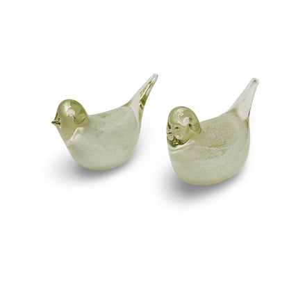 Pair of glass birds with white cores and straw-yellow tinted heads, oblique front view