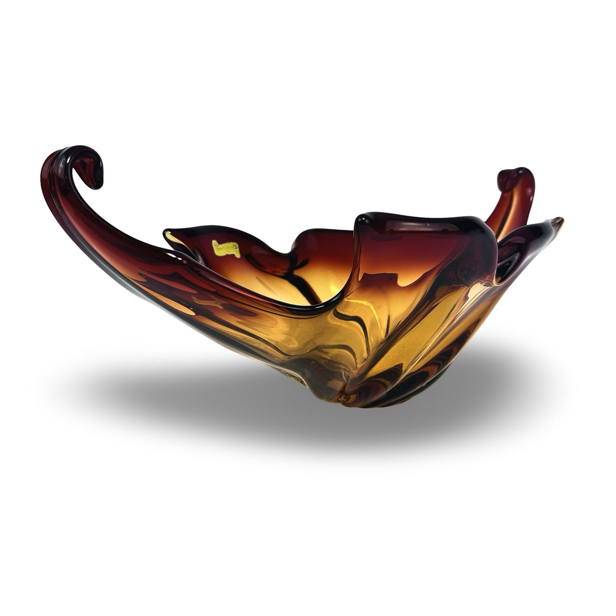 Murano glass bowl in amber and red, angled view with pulled arm and wavy rim