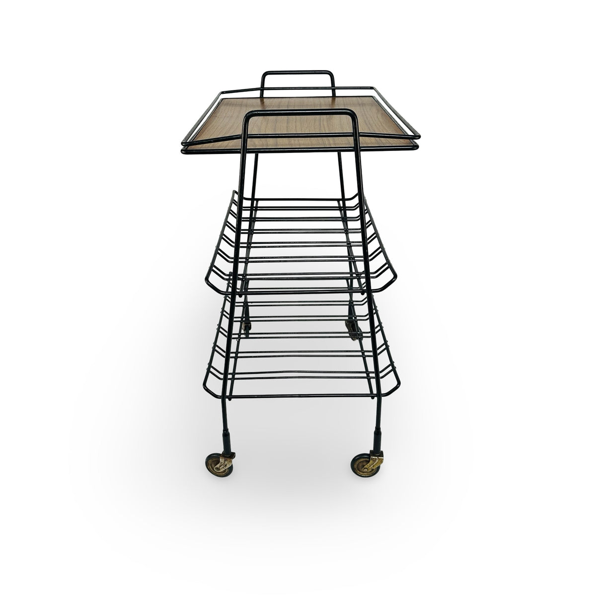 Short side of the serving trolley with handle, splayed legs and V-shaped bent racks